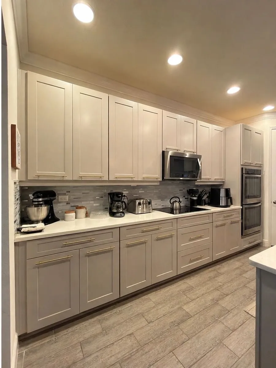 After: Galley kitchen refinished with new gold hardware