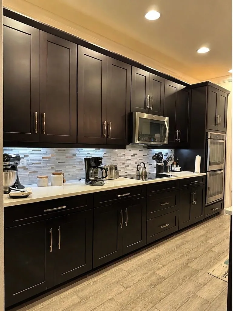 Before: Galley kitchen refinished with new gold hardware