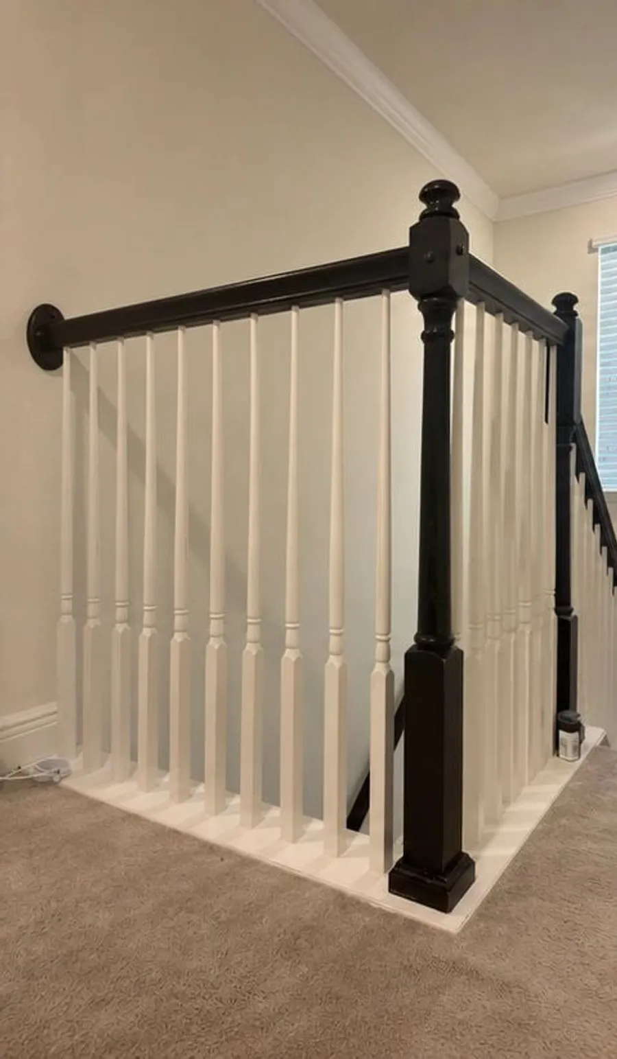 Before: Stair railing and handrail refinished from black to white